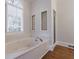 Bright bathroom featuring a soaking tub and separate shower at 2650 Peachtree Battle Nw Pl, Atlanta, GA 30327