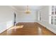 Empty dining room with hardwood floors, chandelier, and large windows offering ample natural light at 2650 Peachtree Battle Nw Pl, Atlanta, GA 30327