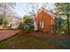 Brick home featuring a sunroom addition and a brick patio, perfect for outdoor gatherings at 2650 Peachtree Battle Nw Pl, Atlanta, GA 30327