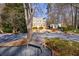 A brick house with a dormer window, surrounded by trees and shrubs and a bench nearby at 2650 Peachtree Battle Nw Pl, Atlanta, GA 30327