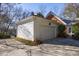 Detached two-car garage with concrete driveway, complementing the brick home's classic design at 2650 Peachtree Battle Nw Pl, Atlanta, GA 30327