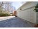 Spacious two-car garage with a neutral door and paved driveway, offering ample parking and storage at 2650 Peachtree Battle Nw Pl, Atlanta, GA 30327