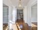 Open hallway with hardwood floors, decorative columns, and a view of the staircase at 2650 Peachtree Battle Nw Pl, Atlanta, GA 30327