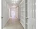 Hallway with tile floors, built-in bookshelves, recessed lighting, and natural light at 2650 Peachtree Battle Nw Pl, Atlanta, GA 30327