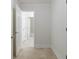 Hallway with tile floors and neutral paint that provides access to many rooms at 2650 Peachtree Battle Nw Pl, Atlanta, GA 30327