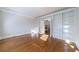 Living room with hardwood floors and built-in bookshelves, leading to the kitchen at 2650 Peachtree Battle Nw Pl, Atlanta, GA 30327