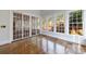 Bright living room with light colored walls, hardwood flooring, and lots of natural light from the large windows at 2650 Peachtree Battle Nw Pl, Atlanta, GA 30327