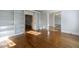 Living room with hardwood floors and built-in bookshelves leading to the dining room and foyer at 2650 Peachtree Battle Nw Pl, Atlanta, GA 30327