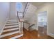 Beautiful staircase with wood treads, white risers, and a view into the bright kitchen at 2650 Peachtree Battle Nw Pl, Atlanta, GA 30327