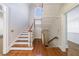 Traditional staircase with hardwood steps and railing, complemented by white risers and walls at 2650 Peachtree Battle Nw Pl, Atlanta, GA 30327