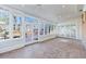 Bright sunroom with brick floor, many windows, ceiling fan, and multiple glass doors to let the light stream in at 2650 Peachtree Battle Nw Pl, Atlanta, GA 30327