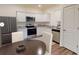 Modern kitchen featuring stainless steel appliances, white cabinets, and an adjacent dining area at 3015 Acacia Cir, Douglasville, GA 30135