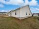 Back exterior view showcasing the backyard, siding and view of other nearby homes at 6782 Gina Agha Cir, Lithonia, GA 30038