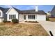 Charming single-story home with white siding, black shutters, and a well-manicured lawn at 6782 Gina Agha Cir, Lithonia, GA 30038