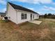 Side view of home featuring white siding, well-kept lawn, and concrete patio at 6782 Gina Agha Cir, Lithonia, GA 30038