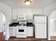 Well-lit kitchen with modern white appliances and neutral color walls at 6782 Gina Agha Cir, Lithonia, GA 30038