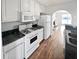 Updated kitchen featuring white cabinets, black countertops, and stainless steel appliances at 6782 Gina Agha Cir, Lithonia, GA 30038