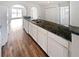 Modern kitchen with white cabinetry, stainless steel sink, and granite countertops at 6782 Gina Agha Cir, Lithonia, GA 30038