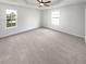 Expansive main bedroom with tray ceiling, neutral walls, and plush carpeting at 6782 Gina Agha Cir, Lithonia, GA 30038