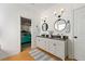 Bathroom featuring a double vanity with black countertop and decorative mirrors at 912 Santa Anita Dr, Woodstock, GA 30189