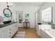 Bright bathroom featuring a shower, bathtub, and a vanity with dark countertop at 912 Santa Anita Dr, Woodstock, GA 30189