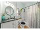 Bright bathroom with shiplap walls, elegant vanity, and shower-tub combination at 912 Santa Anita Dr, Woodstock, GA 30189