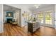 Sunlit dining area featuring an island, hardwood floors, and seamless transition to a cozy living space at 912 Santa Anita Dr, Woodstock, GA 30189