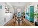 Dining room with designer hutch, round table, and wainscoting with hardwood floors at 912 Santa Anita Dr, Woodstock, GA 30189