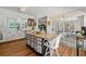 Bright kitchen boasts a decorative island, white cabinets, and sliding doors to an outdoor seating area at 912 Santa Anita Dr, Woodstock, GA 30189