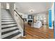 Inviting living room showcasing a fireplace, hardwood floors, and elegant stairs leading to the upper level at 912 Santa Anita Dr, Woodstock, GA 30189