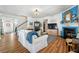 Cozy living room with hardwood floors, a fireplace, and a staircase leading to upper floors at 912 Santa Anita Dr, Woodstock, GA 30189