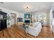 Elegant living room with a fireplace, hardwood floors, and a crystal chandelier providing a comforting atmosphere at 912 Santa Anita Dr, Woodstock, GA 30189