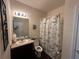 Bathroom with vanity, decorated mirror, toilet, and shower with curtain at 1720 Danville Dr, Mcdonough, GA 30253