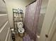 Bathroom with toilet and a shower/tub combo with patterned shower curtain at 1720 Danville Dr, Mcdonough, GA 30253