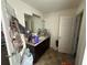 Bathroom featuring single vanity with dark wood cabinets and a framed mirror at 1720 Danville Dr, Mcdonough, GA 30253