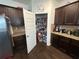 Kitchen with a large walk-in pantry, granite countertops, dark cabinets, and stainless steel refrigerator at 1720 Danville Dr, Mcdonough, GA 30253