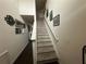 Stairway featuring carpet floors and a white handrail that leads to the home's upper level at 1720 Danville Dr, Mcdonough, GA 30253