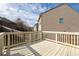 A back deck of a home with a wooden fence in the background at 2066 Charcoal Ives Rd, Lawrenceville, GA 30045