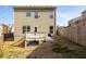 Back exterior of a home with a small deck and a fenced-in backyard at 2066 Charcoal Ives Rd, Lawrenceville, GA 30045