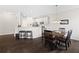 Cozy dining area with hardwood floors, stylish lighting, and adjacent kitchen bar seating at 2066 Charcoal Ives Rd, Lawrenceville, GA 30045