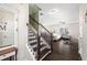 Welcoming entryway showcasing the staircase and open access to the living room with hardwood floors at 2066 Charcoal Ives Rd, Lawrenceville, GA 30045