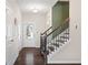 Bright hallway with hardwood floors and staircase leading upstairs at 2066 Charcoal Ives Rd, Lawrenceville, GA 30045