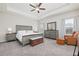 Spacious main bedroom features a ceiling fan, tray ceiling, ample windows, and neutral decor at 2066 Charcoal Ives Rd, Lawrenceville, GA 30045