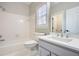 Bathroom with shower-tub combo and gray vanity with white countertop at 3330 Valley Vista Se Rd, Smyrna, GA 30080