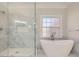 Modern bathroom with soaking tub, glass shower, and stone tile at 3330 Valley Vista Se Rd, Smyrna, GA 30080