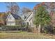 A two-story home with a stone chimney, a waterfall feature, and mature trees on the property at 3330 Valley Vista Se Rd, Smyrna, GA 30080