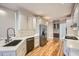 Modern kitchen with white cabinets, stainless steel appliances, and hardwood floors at 3330 Valley Vista Se Rd, Smyrna, GA 30080