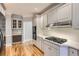 Well-lit kitchen with stainless steel appliances, a wine rack, and beautiful wood flooring at 3330 Valley Vista Se Rd, Smyrna, GA 30080