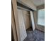 This is a closet with white bi-fold doors and a wire shelf with carpeting at 400 Prince Of Wales, Stone Mountain, GA 30083