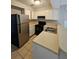 Functional kitchen with white cabinets, black appliances, and neutral countertops at 400 Prince Of Wales, Stone Mountain, GA 30083